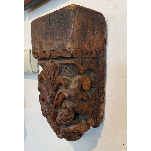 Antique French hand-carved wood corbel wall bracket with bold foliate detail and rich aged patina. A sculptural...