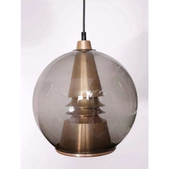 Beautiful pendant lamp. Smoked Glass dome and comes with a Bronze color Aluminum shade inside .Very good quality piece ....