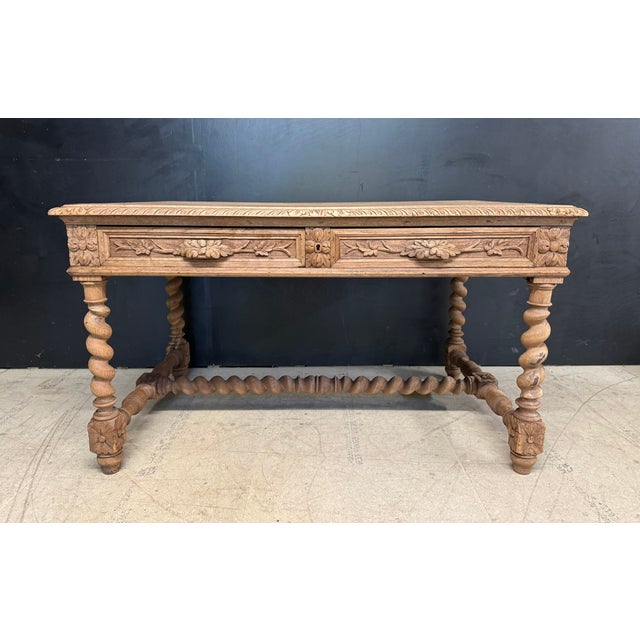 A French Carved Oak Desk or Centre Table, dating to the mid 19th Century and having 2 drawers to the front. It is carved...