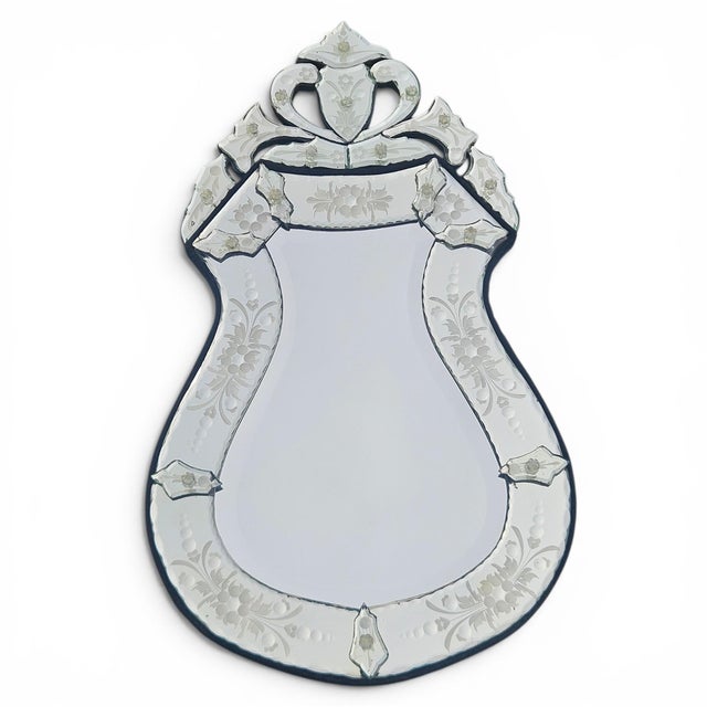 This stunning Venetian-style mirror is a true showstopper, featuring a rare and elegant shield-shaped silhouette that adds...