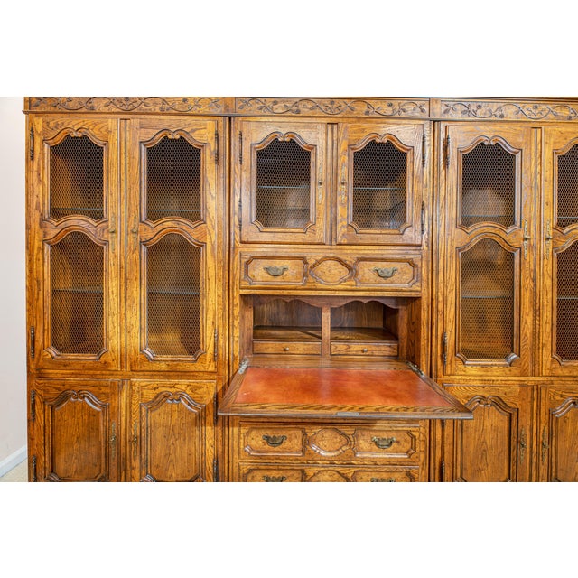 This Milling Road by Baker Furniture breakfront cabinet combines display cabinetry with a functional drop-front secretary...