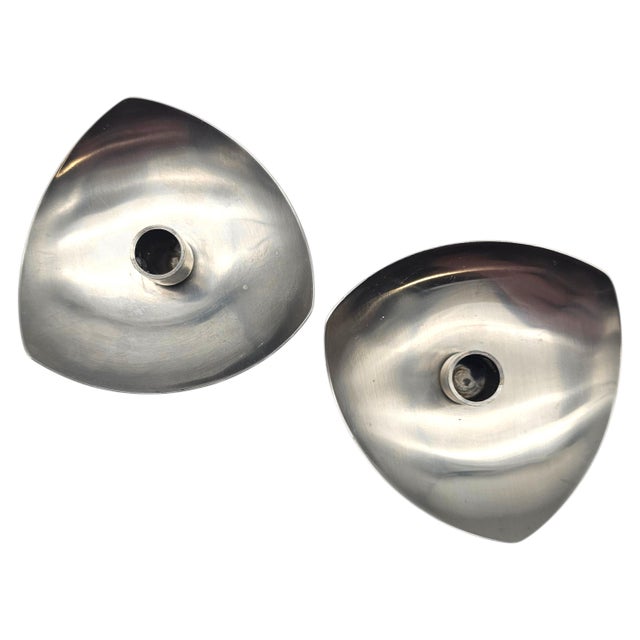 A refined pair of Danish modern stainless steel taper candle holders attributed to Stelton Denmark, exemplifying the...