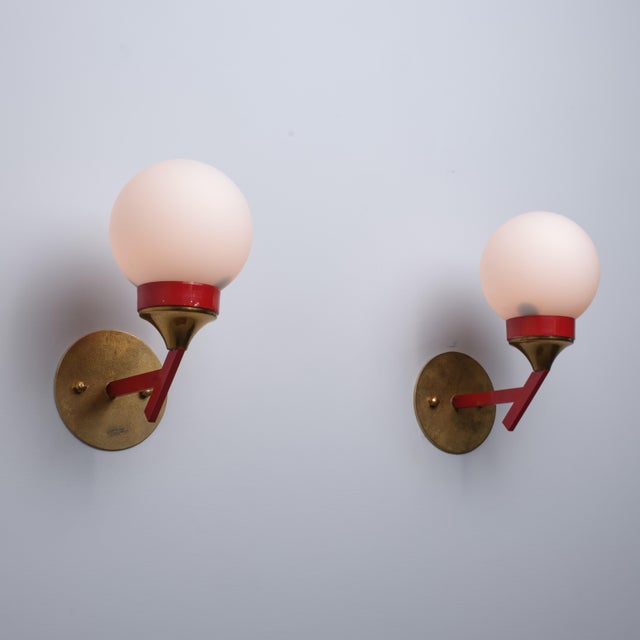 Pair of italian wall sconces dating from the 1950s, characterized by a bold geometric composition and a distinctive...