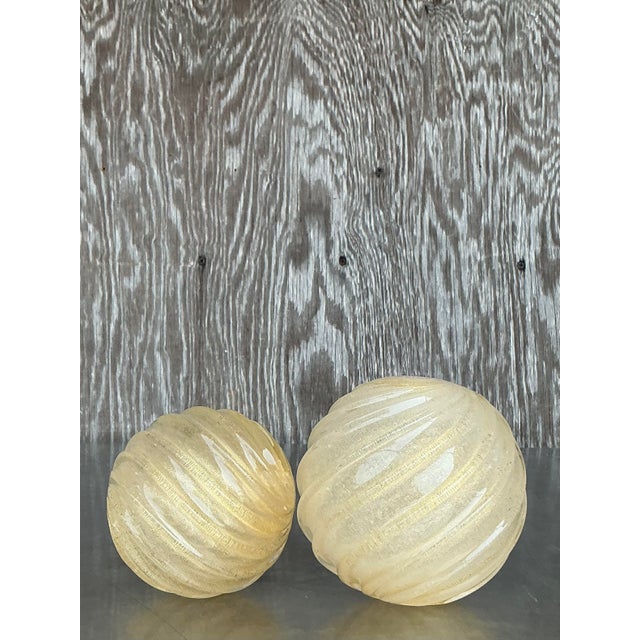 Elevate your space with this stunning set of two Vintage Regency Swirl Blown Glass Spheres - an elegant fusion of...
