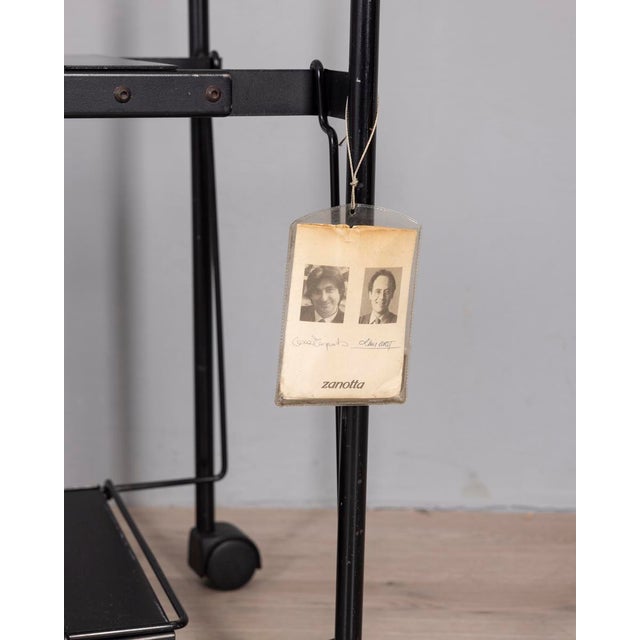 Black metal TV stand, "Teulada" model, designed by Lluis Clotet and Oscar Tusquets Blanca for Zanotta, 1990s. This piece...