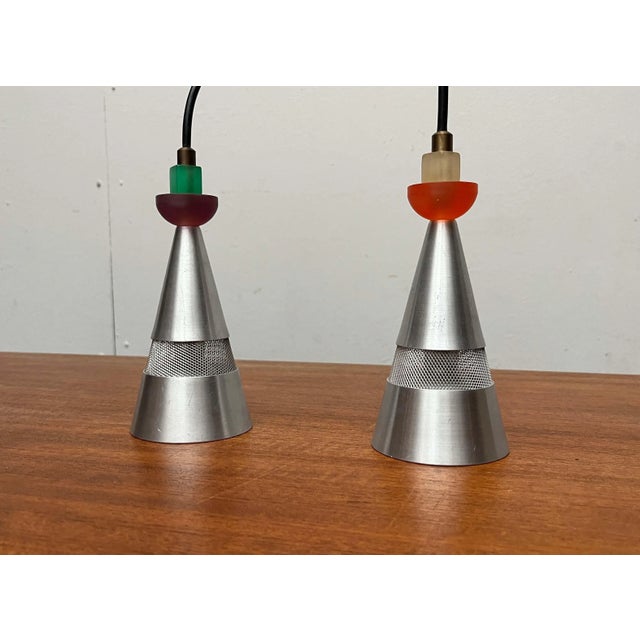 Postmodern pendant lights from the Dutch manufacturer Studio Brandend Zand. The light bodies have a simple conical shape....