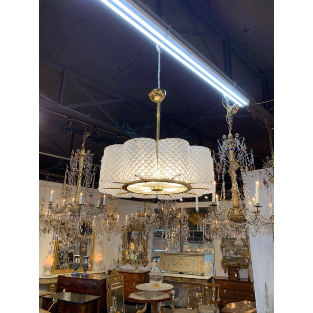 Stunning Murano glass and brass chandelier. Very pretty sections of white toned Murano glass with brass base. Notice the...