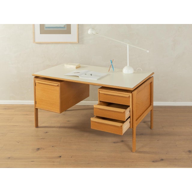 A classic freestanding desk from the 1960s by Arne Vodder. High-quality oak veneer cabinet with three drawers, one door,...