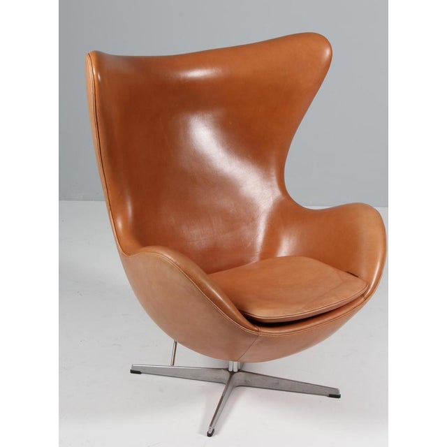 Arne Jacobsen lounge chair model Egg. Original upholstered with patinated Grace full grain aniline leatherleather. Four...
