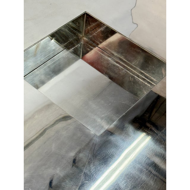 Striking Italian coffee table from the 1970s, crafted entirely in polished steel. Its square architectural form features...