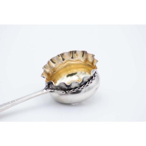 Silver Tea Strainer with Gold Interior and Reliefs on the Handle, in Very Good conditions. Designed 1890 to 1919 This...