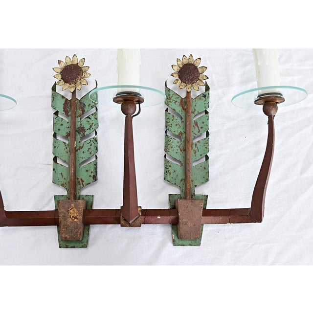Italian vintage sunflower motif tole-painted wall sconce sprouting stylized flowers lit by three candelabra-base bulbs for...