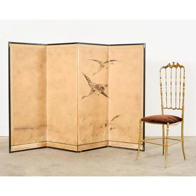 Muromachi period inspired Japanese four panel byobu screen depicting wild geese in flight over reeds. The 19th century...