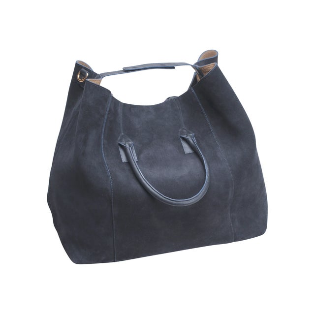 Go in style. This impeccably made tote features Italian suede and Napa leather in sumptuous colors with the best hardware...