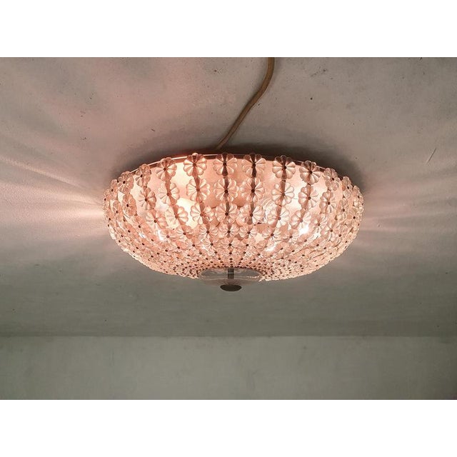 About this item Ceiling light with glass flowers. In the style of Rupert Nikol. Up to 250V (Europe/UK Standard).The wiring...