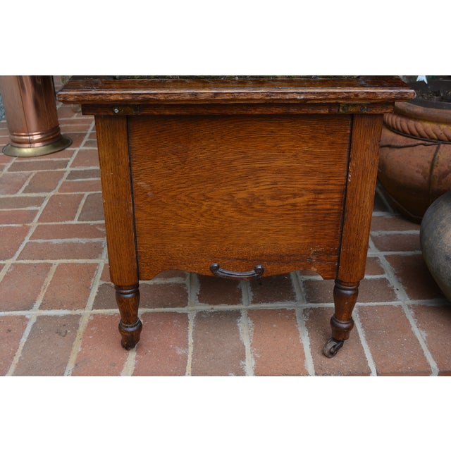 This is an antique chamber pot cupboard from England. I believe it is oak & it is on castors. Single metal latch for the...