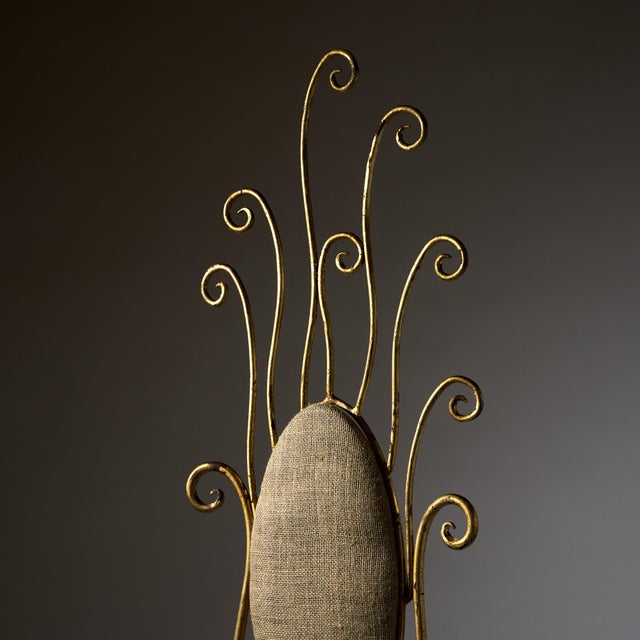 A whimsical Italian vintage vanity or boudoir chair constructed in gilt wrought iron with an upholstered seat and back....