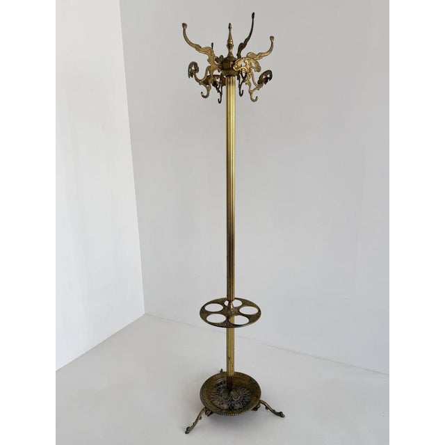 This impressive vintage Italian brass hall tree combines practical functionality with luxurious decorative appeal....