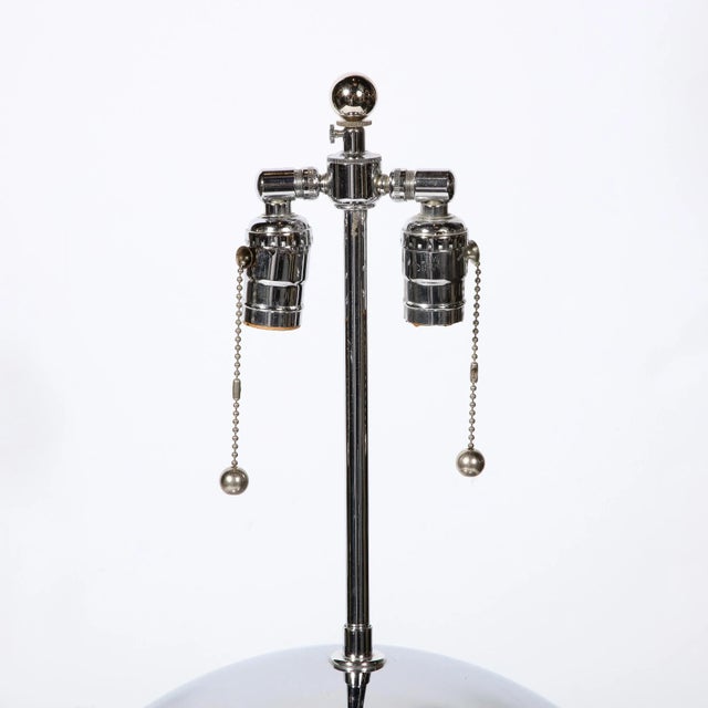 Mid-Century Modernist "Ball" table lamp in chrome, style of Karl Springer. Two demi-spheres of polished chrome meet along...