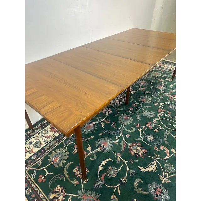 Transform your dining room with a Mid-Century Modern Expandable Dining Room Table. This table combines sleek lines and...