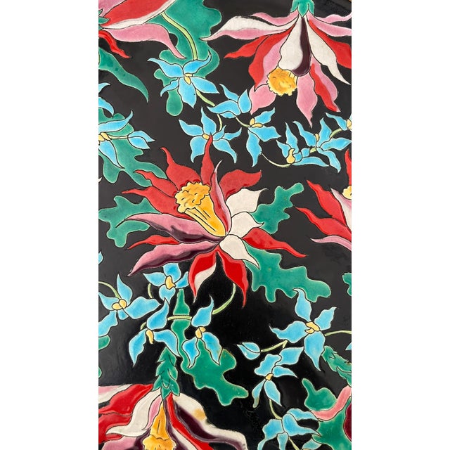 Rare Longwy glazed earthenware dish, Tropic pattern Hanging on the back for wall mounting Signed 35cm diameter This piece...