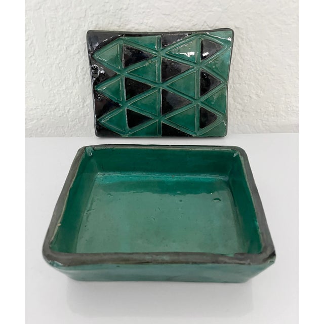 Mid-Century Modern 1960's glazed ceramic cigarette or trinket box. Featuring coloring and handmade characteristics that...