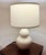 Elegant pair of Ethan Allen ceramic table lamps featuring a soft cream glaze and classic gourd silhouette on a brass base....