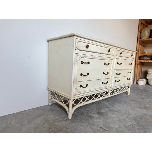 This beautifully crafted vintage Ficks Reed dresser, featuring an elegant rattan and faux bamboo frame finished in a soft,...