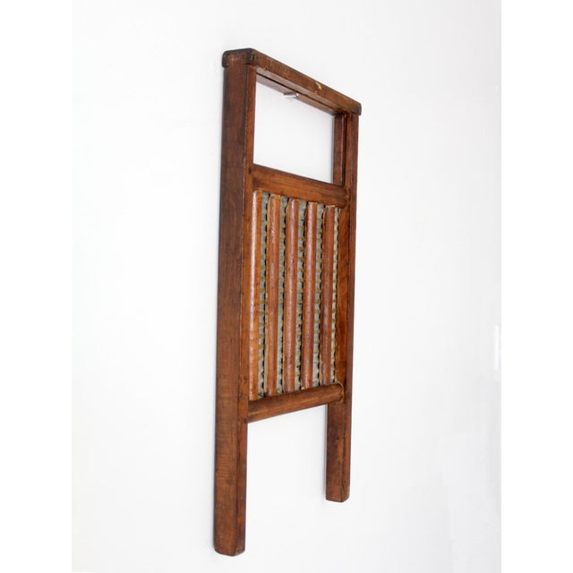 Antique double-sided washboard featuring a warm wood frame, galvanized metal scrubbing surface, and slatted wood reverse....