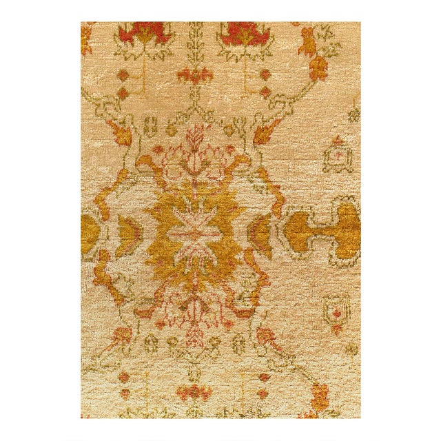 An early 20th-century room size Antique Turkish Oushak rug in predominantly ivory and orange with teal and brown...