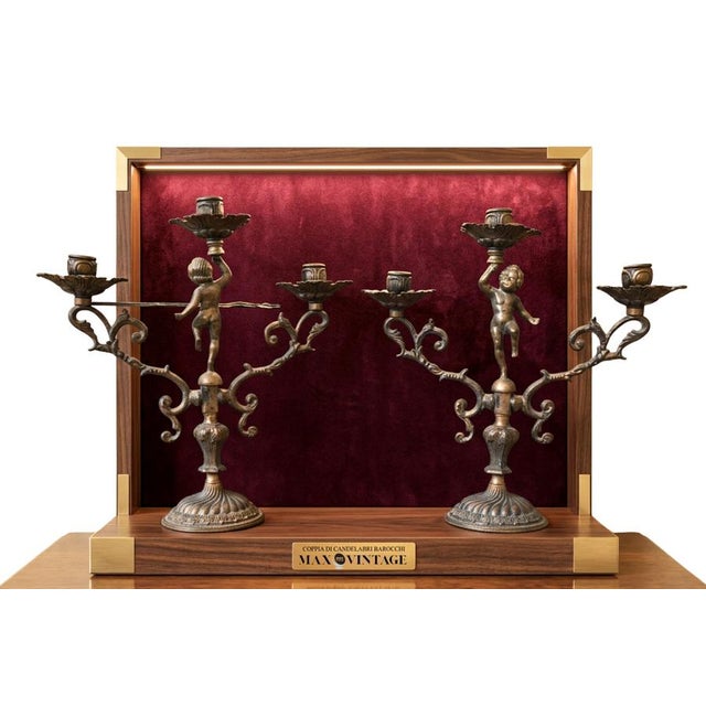 A prestigious pair of three-light candelabras crafted entirely from solid bronze with a beautiful original dark patina....