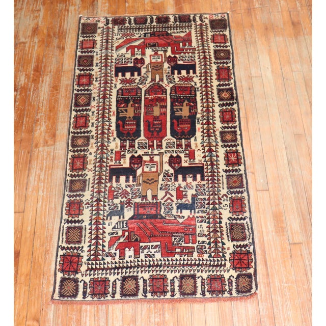 A mid 20th Century Persian Balouch rug depicting a pictorial design. Measures: 2'11'' x 5'10''.