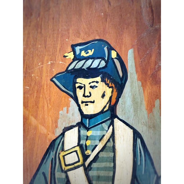 A striking piece of mid-century Americana folk art, hand-painted on a naturally irregular, hand-hewn wooden slab. The...