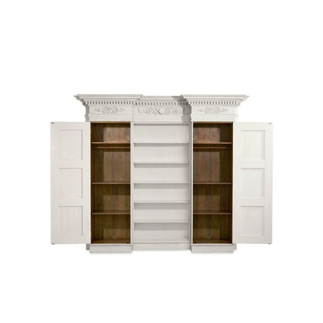 Inspired by a 19th-century French bibliothèque with neoclassical dental molding cornice and raised panel doors exemplifies...