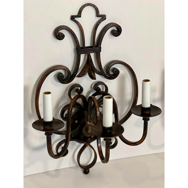 Stunning pair of Italian hand wrought iron sconces with a blackened rust finish. Crafted in early 2000s but have never...