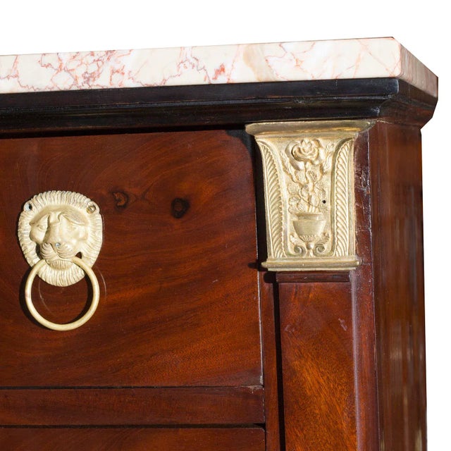 A fine French Neoclassical bronze mounted semmonier with marble top. There are seven drawers with glowing mahogany fronts...