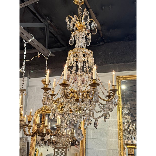 This 19th century French Baccarat-inspired bronze and crystal chandelier exudes elegance and sophistication. Featuring...