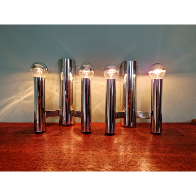 Pair of double tubular wall sconces in chromed metal, designed by gaetano sciolari for the belgian manufacturer boulanger,...