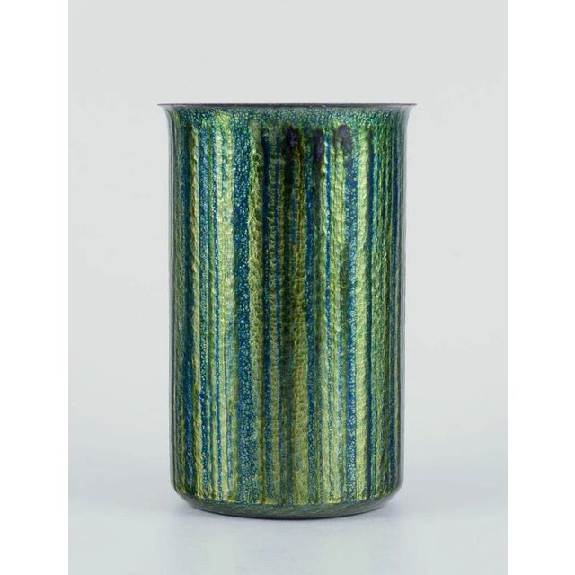 Norwegian designer. Enamelled copper vase. Cylindrical shape. Glossy green and blue tones. Circa 1970s. Label from...