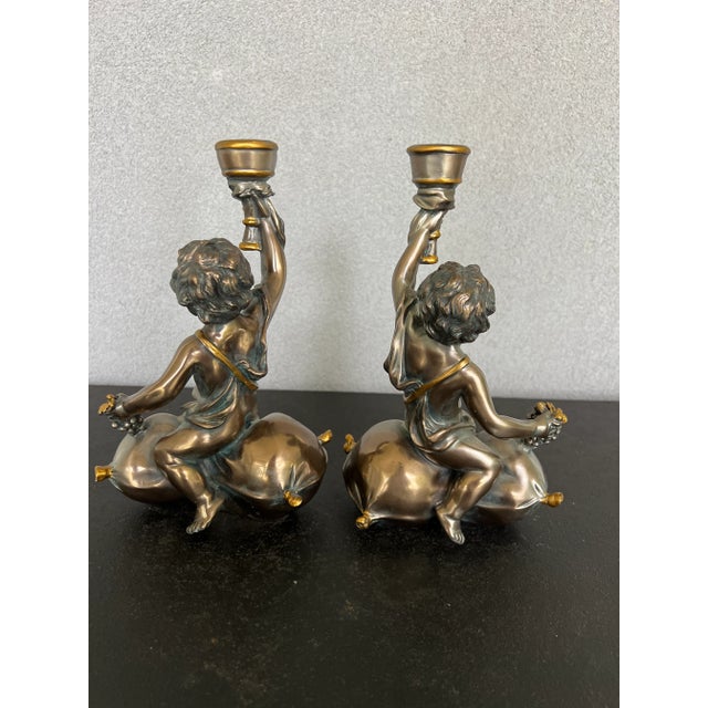 Gorgeous pair of Bacchus candlesticks in an antique bronze color, I believe they are made of resin. Beautiful details...