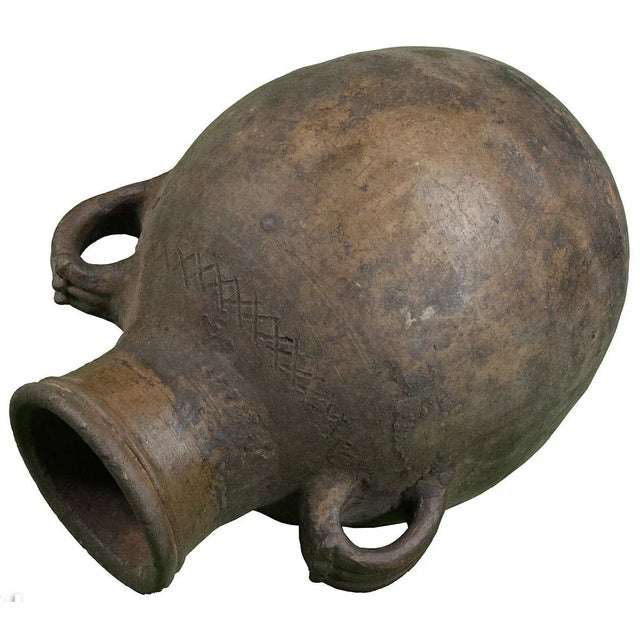 Hand-crafted clay water jar with handles. Ornate round base and intricate details. Pottery is an essential part of Berber...