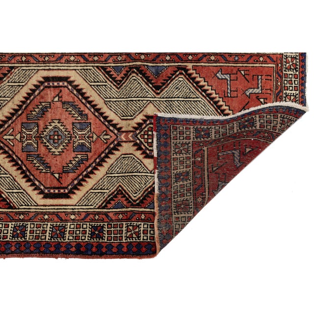 Elevate your space with this exquisite vintage Turkish wool runner, featuring a striking tribal design with bold geometric...