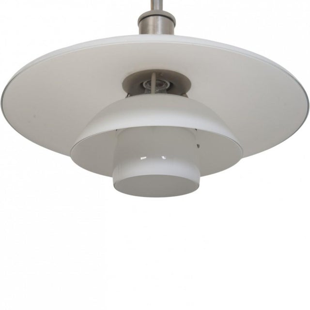 Poul henningsen ph 4½/3½ pendant lamp with white opal glass shades and a chrome aluminium socket housing. The lamp is from...