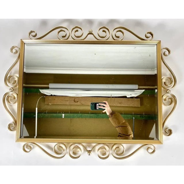Vintage mirror in neoclassical vintage style mid 20th century. In the neoclassical «Hollywood Regency» style with gilt...