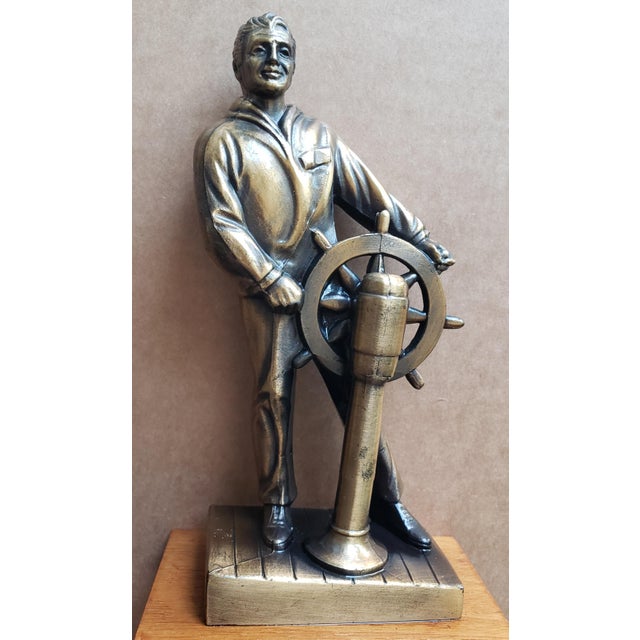 Vintage Nautical Sculpture Bronze-finish sailor statue by sculptor Ferdinand G. Rebechini, depicting a helmsman standing...