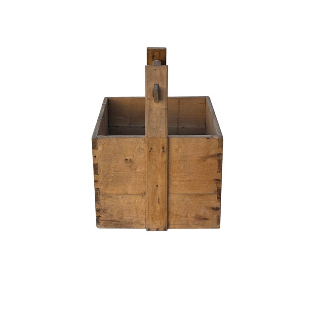 This antique square wooden bucket, reminiscent of a traditional Chinese grain storage container, offers a unique blend of...