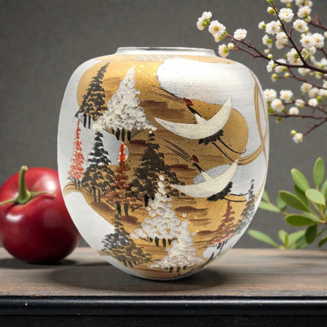 A refined example of late 20th-century Kutani ware, this hand-painted Japanese porcelain vase presents a lyrical crane...