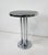 A smaller scale chromed side or cigarette table with round chrome banded black Formica top by the iconic Art Deco designer...