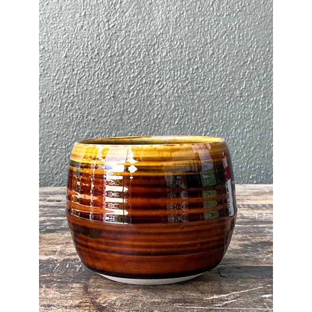 This vintage brown studio pottery bowl is a handsome example of mid-20th-century handcrafted ceramic design, celebrating...
