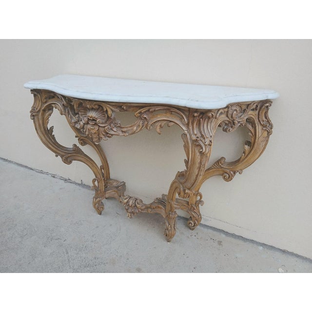 Wonderful carving. Shaped Carrara marble with double-grooved molding. \. As for the rest, I don't want to bore you with...